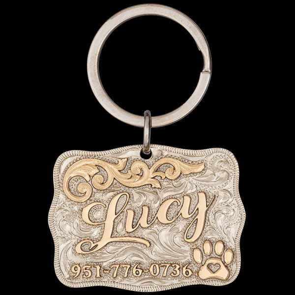 Elevate your pet's ID game with the Lucy Custom Dog Tag! Crafted from durable German silver, adorned with bronze letters and adorable paw designs. Keep your furry friend safe and stylish. Order now!